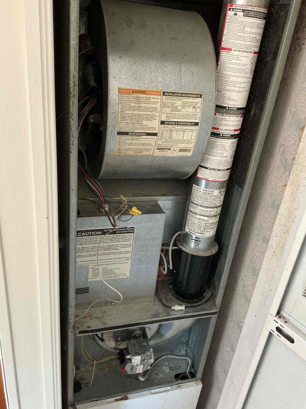 Responded to no heat call on 25-year-old furnace with complete system failure—no thermostat display, fan operation, or heating/cooling capability. Diagnostic testing revealed no indicator lights on furnace control board. Verified 120V supply to control board but measured zero voltage output from transformer despite proper 120V input, indicating transformer failure. Replaced defective transformer, restored power to control circuit, and successfully tested system operation. Unit now firing properly with all functions operational.