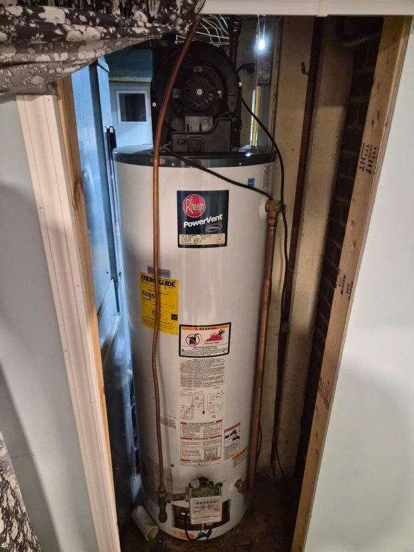 Responded to no hot water complaint on 2009 Rheem PowerVent natural gas water heater experiencing ignition failure. Unit would not maintain flame and burner would not light upon startup. Performed diagnostic testing including cleaning flame sensor, verifying vent system was clear and unobstructed, and testing pressure switch operation which confirmed proper function. Checked for spark at ignition but observed no spark generation throughout multiple attempts. Based on diagnostic findings, determined likely internal wiring failure within gas valve assembly preventing proper ignition sequence. Provided estimate for complete water heater replacement due to age of unit and cost-effectiveness of replacement versus repair of failed gas valve component.