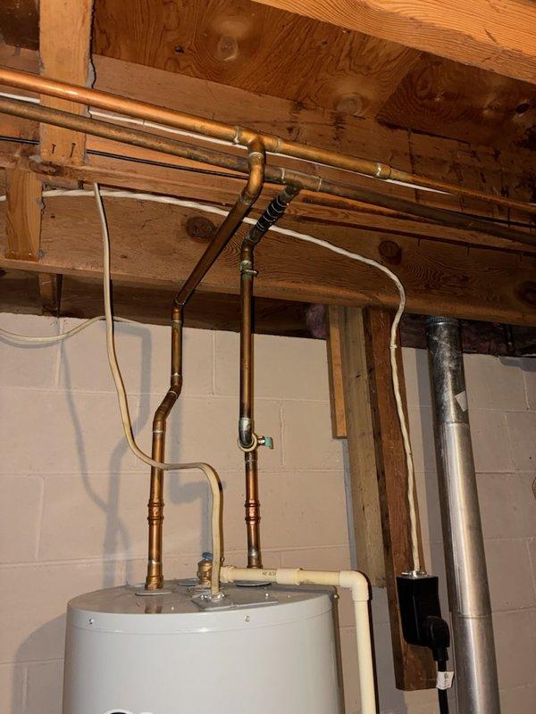 Responded to emergency water leak in basement caused by pinhole failure in copper supply line. Upon inspection, found copper piping exhibited severe deterioration with extremely soft and thin pipe walls, indicating advanced corrosion and imminent failure risk. Successfully repaired the active leak in the copper pipe using appropriate fittings and techniques. Due to the compromised condition of the existing copper plumbing system throughout the property, scheduled full house water repipe to prevent future failures and ensure system integrity.