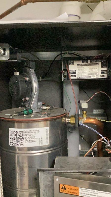Responded to no hot water complaint and found boiler controller board failed with blank display screen preventing system operation. Replaced defective V-15 control board and performed complete system reset. Programmed all heating zones and domestic hot water settings, then cycled system to verify proper operation. Adjusted and set gas pressures and combustion parameters to manufacturer specifications. Purged air from all heating zones and verified auto-fill operation and settings. Secured loose wiring and thermostat wires that were left hanging from previous remodeling work. Identified damaged air relief valve caused by prior system freeze event and ordered replacement cartridge for future installation. System restored to normal operation with all zones functioning properly.