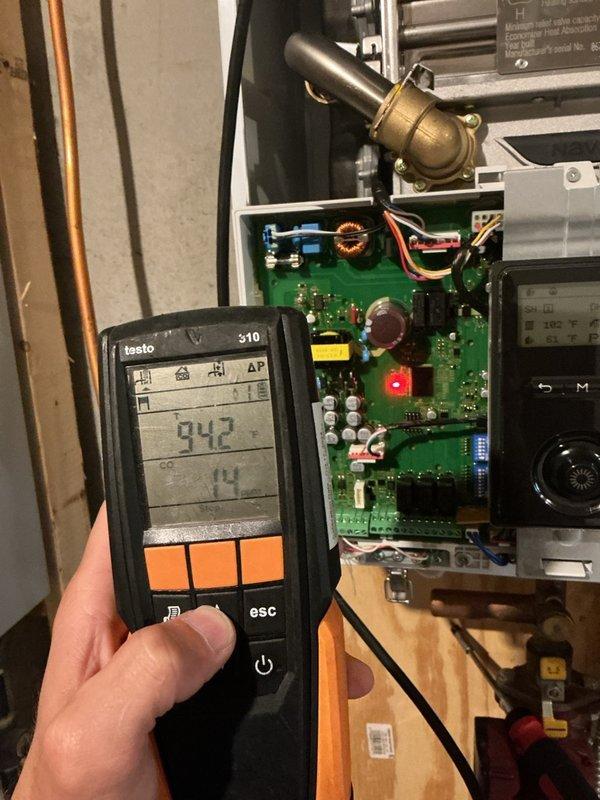 Completed preventive maintenance on high efficiency boiler with in-floor heating system and air exchanger unit. Cleaned and scrubbed flame sensor, verified system pressure at 16 PSI within acceptable range, and tested both heating zones for proper operation with satisfactory warm-up. Conducted carbon monoxide safety test measuring 14 PPM, confirming safe operational levels. Inspected air exchanger filter and found in good condition. Cleaned exterior ventilation to ensure proper airflow to air exchanger. All systems tested and verified ready for winter operation.