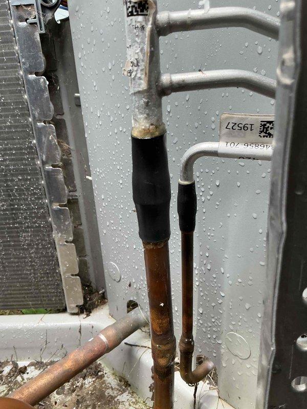 Responded to no cooling complaint on 5-year-old Heil air conditioning system. Upon arrival, homeowner reported that original installer had diagnosed low refrigerant charge due to leak but was unable to schedule repair for another week. Performed visual inspection of outdoor condensing unit and identified significant oil accumulation at the junction where copper refrigerant lines connect to aluminum condenser coil, confirming active refrigerant leak at coil connection point. Documented corrosion and moisture present on refrigerant lines and coil assembly with photographic evidence. System was verified to be significantly undercharged, rendering unit unable to provide adequate cooling. Discussed findings with homeowner regarding refrigerant leak at condenser coil and repair options. Submitted parts request to obtain pricing for condenser coil replacement, noting that unit age falls within typical warranty coverage period. Recommended condenser coil replacement as primary repair solution 