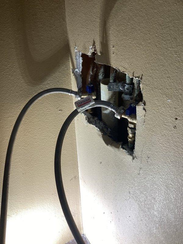 Responded to leaking laundry connections where outdated shower shutoff valves were failing at the hot and cold water supply lines for the washing machine. Removed the old defective valves and installed new boiler drains to provide reliable shutoff capability and eliminate the active leaks. System was tested and confirmed operational with no further leakage detected.