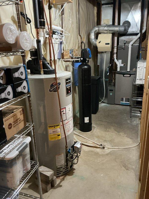 Completed comprehensive plumbing inspection of residential property including evaluation of washing machine supply lines, shut-off valves, water heater connections, and water treatment system components. All plumbing fixtures, connections, and mechanical systems were visually inspected and found to be in proper working condition with no leaks or immediate concerns identified.