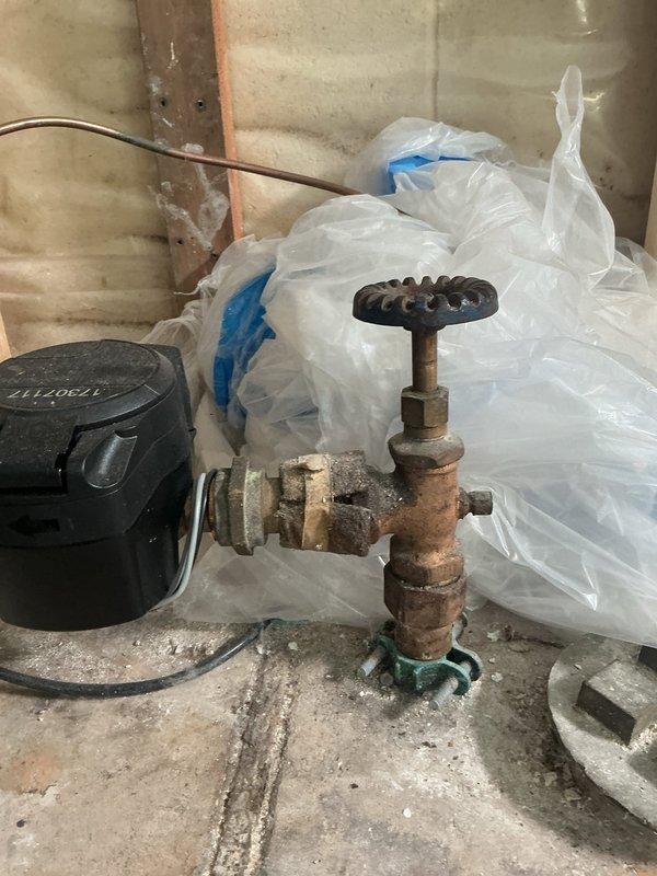 Responded to service call for water heater leaking from bottom. Upon inspection, determined the discharge valve was the source of the leak, not the tank itself. The combi unit was running excessively hot, and the recirculation pump was found unplugged. Intermittent leaking observed - unit not actively leaking during service but evidence of significant water discharge when failure occurs. Due to age of equipment, condition of corroded valve assembly, overheating issues, and mixing valve concerns, recommended full system replacement rather than repair.