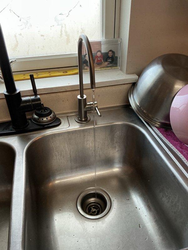Responded to kitchen sink with no water flow following homeowner's faucet cord replacement, slow-filling toilet, and leaking reverse osmosis system. Upon inspection, determined check valve in kitchen faucet was installed backwards, preventing water flow. Corrected check valve orientation to restore proper water supply to sink. Diagnosed plugged fill valve in toilet causing slow tank refill. Removed and replaced defective fill valve with new unit to restore proper flush cycle. Removed leaking reverse osmosis system per homeowner request as unit was not in use. Tested all repairs to verify proper operation of kitchen faucet and toilet function.