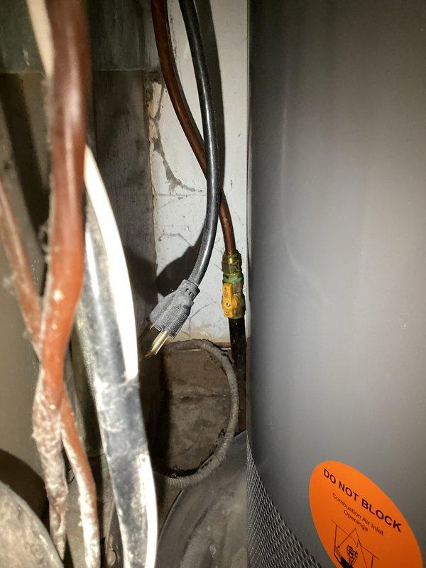Responded to reported gas leak at 30-year-old furnace and water heater. Performed comprehensive leak detection using soap bubble test on furnace control valve, gas supply lines, and all fittings and connections. No active leaks detected at furnace gas valve assembly or supply piping during testing. 

Upon further inspection, discovered evidence of melting and heat damage at top of water heater, indicating potential backdrafting condition. This represents a safety hazard as combustion gases may not be properly venting, creating risk of carbon monoxide exposure and equipment damage. Documented findings with photographs showing furnace gas valve assembly, blower motor housing, and mechanical components in utility space.

Recommended replacement of aging furnace with high-efficiency unit featuring alternative venting configuration to eliminate backdrafting concerns and improve system safety. Coordinated with licensed plumber to evaluate water heater venting system, verify gas connections a
