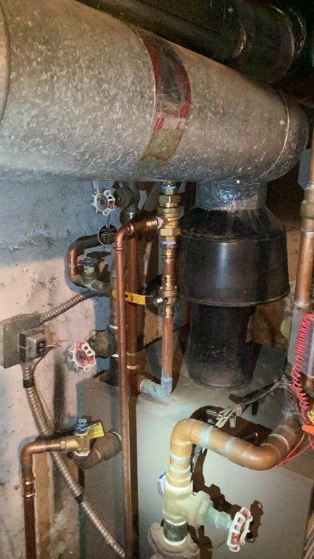Completed comprehensive boiler repair including replacement of backflow preventer with ball valves on both sides, relief valve, temperature gauge, and zone valve. Performed system draindown and refill over four hours, purged air from all zones, cycled the heating system through all zones to verify proper operation, and confirmed system returned to normal operating parameters.