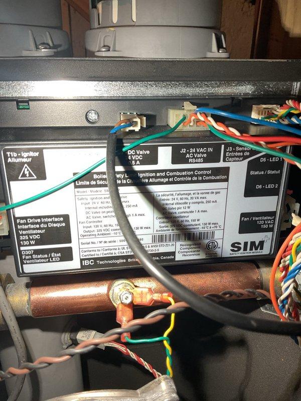 Responded to service call for boiler making unusual "mooing" noise after system was switched from geothermal to boiler heating mode. Ran boiler for approximately 20 minutes but did not observe the reported noise; suspected moisture on burner caused temporary dirty combustion that has since resolved. During inspection, discovered low water cutoff safety control was triggering and causing system alarm. Cleaned low water cutoff and added water to boiler, but safety control continued to alarm, indicating component failure requiring replacement. Ordered replacement low water cutoff and ignition module board as precautionary measure. Tested geothermal system operation and confirmed proper function. Additional boiler cleaning in garage required upon return visit to complete work with ordered parts installation.