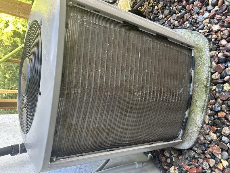 Completed comprehensive tune-up on furnace and air conditioning system. Tested furnace operation, verified humidifier function, confirmed proper temperature rise, cleared condensate drain, cleaned flame sensor, inspected igniter, checked blower compartment, and verified gas pressure—all within normal parameters. Switched to cooling mode and performed condenser coil wash. During AC performance testing, identified inadequate cooling and discovered system was low on refrigerant charge with abnormal pressure detected at service port. Added approximately one pound of refrigerant to achieve proper subcooling of 11-12°F, replaced valve cores, and injected UV dye for future leak detection. Performed preliminary leak check on evaporator coil with refrigerant detector with no leaks indicated. Advised monitoring charge levels at next annual service to determine if slow leak is present.