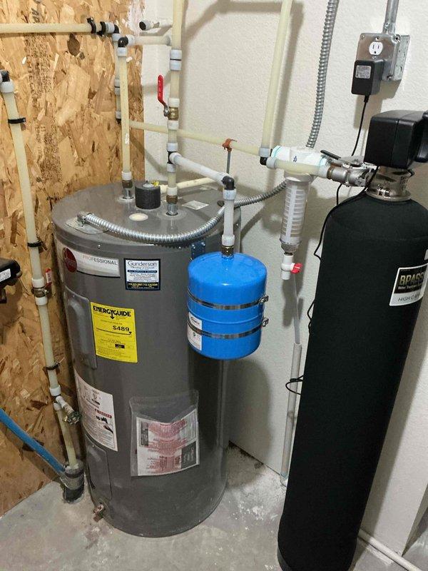 Installed thermal expansion tank on residential tanked water heater to comply with Wisconsin plumbing code requirements. The home is equipped with a pressure reduction valve, which necessitates proper thermal expansion management. Static water pressure measured at 80 psi; expansion tank pre-charged to 78 psi to match system specifications. All connections secured with appropriate PVC and flexible metallic piping, red-handled isolation valve installed for future serviceability. System tested and verified operational with existing whole house water filtration equipment.