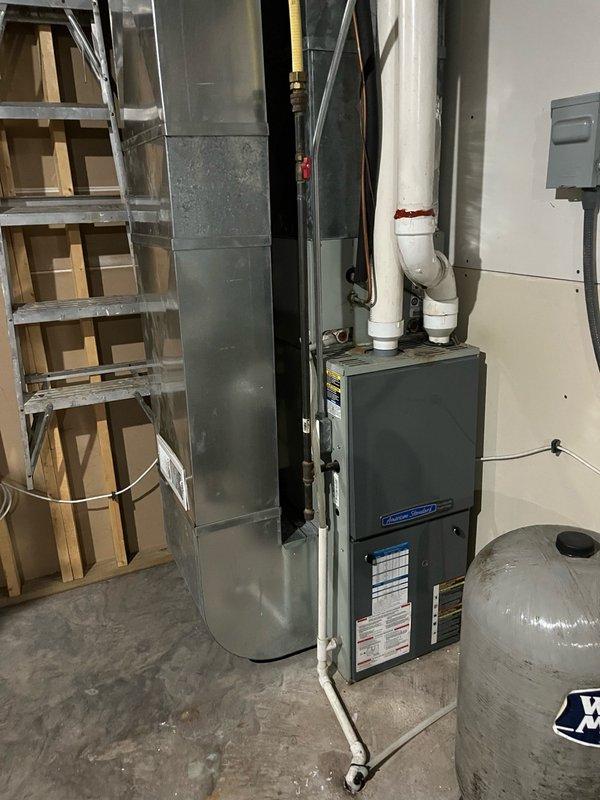 Completed comprehensive furnace tune-up on 20-year-old American Standard unit. Performed full inspection of all routine components, cleared drainage lines, and conducted safety inspection. Identified early-stage burner inlet cracks typical of American Standard/Trane units, currently small and not extending past riveting points. All components tested within manufacturer specifications. Conducted 15-minute operational test with 65° temperature rise, confirming proper system performance. Discussed unit age, current condition, and maintenance program options with homeowner.