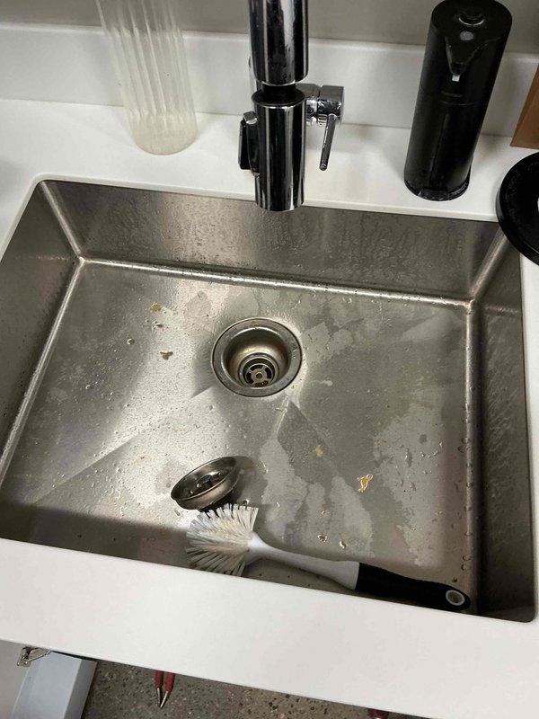 Responded to a clogged break room sink that was backing up with debris. Upon inspection, removed the tubular trap and discovered significant accumulation of grease and food debris throughout the drain line. Manually cleared all debris from the tubular section, then used a drain cable to clear the entire drain line from the fixture to the mainline connection. Successfully dislodged and flushed a large volume of food waste and grease buildup that had caused the blockage. Reassembled all components and performed operational testing to verify proper drainage and flow. System restored to full working order with no backup issues observed.