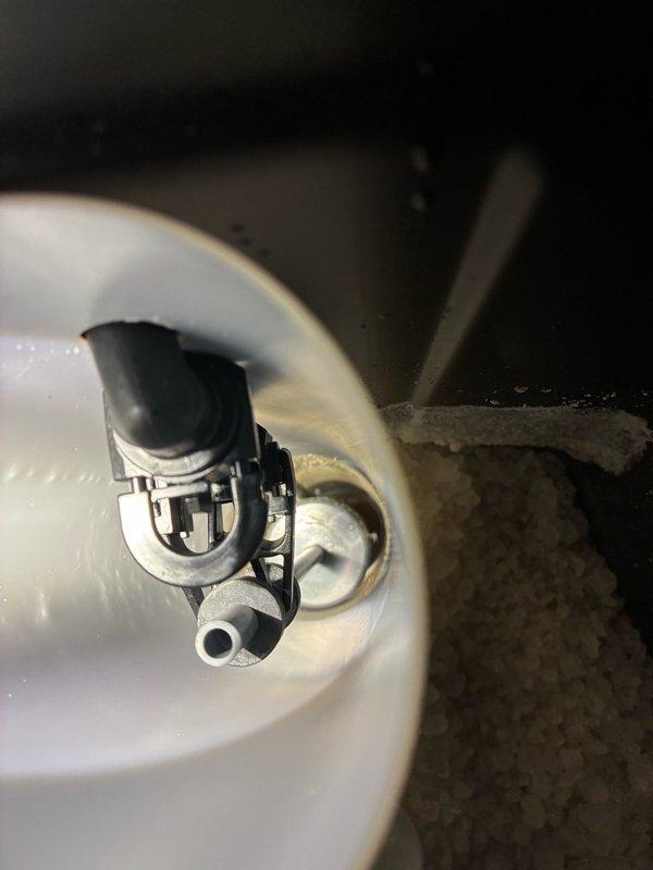Responded to water softener system continuously draining to waste. Upon arrival, diagnosed unit stuck in rapid rinse cycle due to rotating disc spindle dislodged from piston head slot. Disassembled power head and removed piston assembly with spacer kit for inspection. Applied fresh lubricant to rubber seals and piston components. Repositioned disc spindle back into proper slot within piston head, removed control board to access mechanism, and reseated all components. Reassembled power head and conducted multiple dry cycle tests to verify proper rotation and positioning. Restored water supply and flushed system to confirm normal operation and proper cycling sequence.
