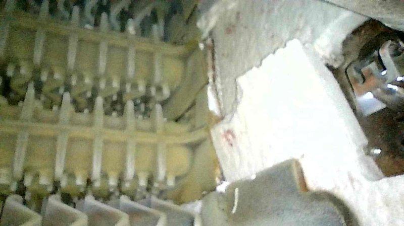 Responded to no heat call for 1998 Buderus boiler. Upon inspection, found refractory material deteriorated and falling apart, causing impingement on the burner assembly. The rollout switch was also compromised and removed. Due to the age and specialized nature of this Buderus unit, proper OEM replacement parts are required for safe repair. Submitted parts request for pricing on refractory and rollout switch components. System remains non-operational pending parts availability, and replacement boiler options are being evaluated given the unit's age and parts availability concerns.