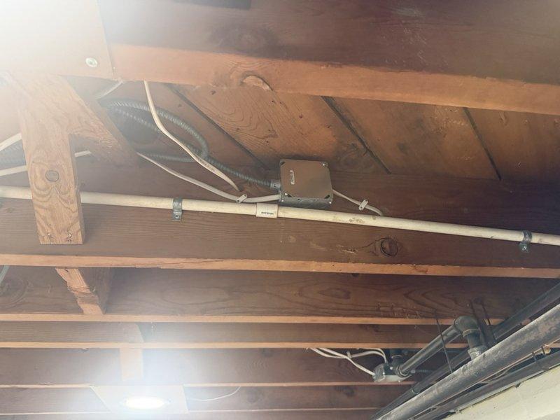 Conducted follow-up call to address customer concerns regarding initial estimate and fixture options. Discussed alternative fixture selections that would maintain proximity to existing configurations while meeting budget expectations. Documented garage ceiling infrastructure including exposed joists, garage door opener assembly, and electrical components to support revised estimate preparation.
