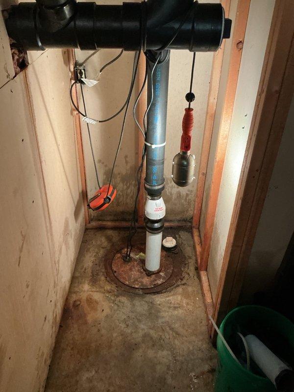 Installed a new sewage ejector pump system up to 1/2 HP with complete float switch assembly to remove black water sewage and maintain proper flow to the absorption area. Replaced check valve assembly using 2" PVC piping with up to 3 feet of connections, incorporating "The Quiet Check Valve" technology with rubber coupling connectors to gray metal discharge piping. Float switch positioned above potential flood level to ensure reliable pump activation and prevent water damage in basement area.