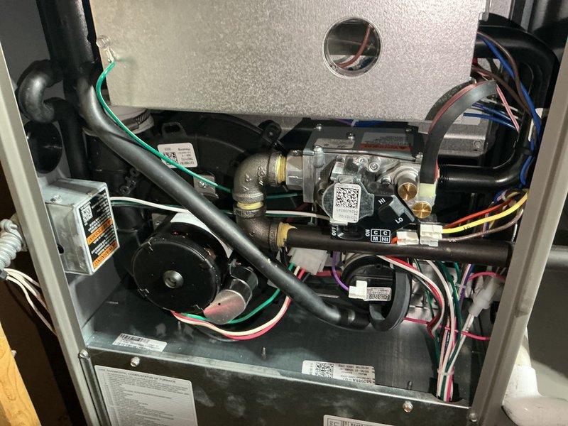 Completed comprehensive furnace tune-up on one-year-old system under warranty. Verified all components operating within manufacturer specifications, confirmed proper gas pressure levels, and tested carbon monoxide levels in flue with safe readings. Provided customer instruction on thermostat programming and setup upon request, ensuring proper system operation and user understanding of controls.