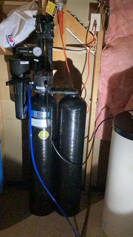 Responded to service call for emergency shut-off valve installation consultation to prevent potential flooding when property is unoccupied. Conducted comprehensive assessment of existing plumbing infrastructure, including water treatment system with dual filtration tanks, boiler unit, and associated copper piping network. Provided detailed estimates for emergency shut-off valve installation, whole-home water sensor system, and complete residential repipe of aging plumbing components. Documented existing conditions with photographs showing current water filtration setup, heating system connections, and copper supply lines exhibiting normal wear patterns. Customer requested same-day installation capability for emergency shut-off valve to address immediate concerns about unattended water damage risk.