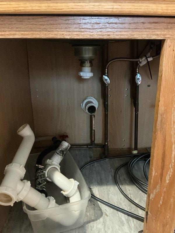 Responded to a main line drain stoppage affecting the kitchen sink and dishwasher. Upon inspection, discovered the sink drain was clogged with an accumulation of hair and grease buildup causing water to back up and prevent proper drainage. Utilized a drain snake to clear the obstruction from the line, restoring full flow and drainage capability to both the kitchen sink and dishwasher.