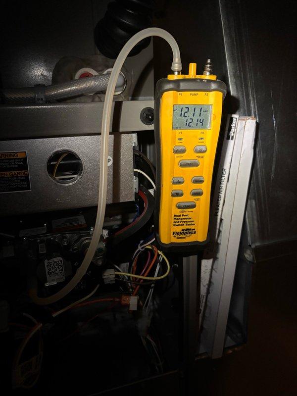 Completed startup and commissioning of LP gas furnace installation. Performed diagnostic testing using digital manometer to verify proper gas pressure readings at manifold, confirming system operating within manufacturer specifications. Verified all electrical connections, tested ignition sequence, and confirmed proper airflow through pleated air filter assembly. System operational and left in service.