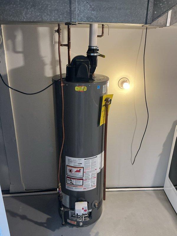 Responded to emergency call for leaking water heater. Upon arrival, found water actively leaking from the bottom of the existing 40-gallon power vent water heater tank, indicating internal tank failure requiring immediate replacement. Water supply to the unit was shut off to prevent further water damage.

Removed the failed 40-gallon power vent water heater from the installation location. Installed new Bradford White 40-gallon power vent water heater as replacement unit. Connected new water heater to existing copper water supply lines with appropriate fittings and shut-off valves. Made gas line connection to burner assembly using existing gas supply piping. Connected power vent exhaust system to existing ventilation ductwork to ensure proper combustion gas venting.

Restored water supply and gas supply to the new unit. Performed complete system startup and operational testing. Checked all water connections for leaks under pressure. Verified proper gas combustion and burner operation. C