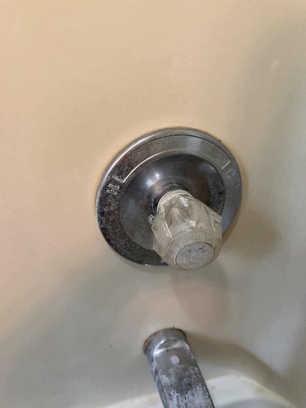 Completed plumbing inspection to assess water leak concerns and evaluate existing plumbing fixtures. Examined sink faucet operation and drainage system, noting active water flow and proper drain function. Inspected bathtub/shower valve assembly and identified mineral buildup on handle and escutcheon plate, along with hard water deposits on shower arm components indicating age-related wear. Documented fixture conditions with photographs and prepared estimates for recommended repairs and potential fixture replacement based on undetermined age of existing plumbing system.