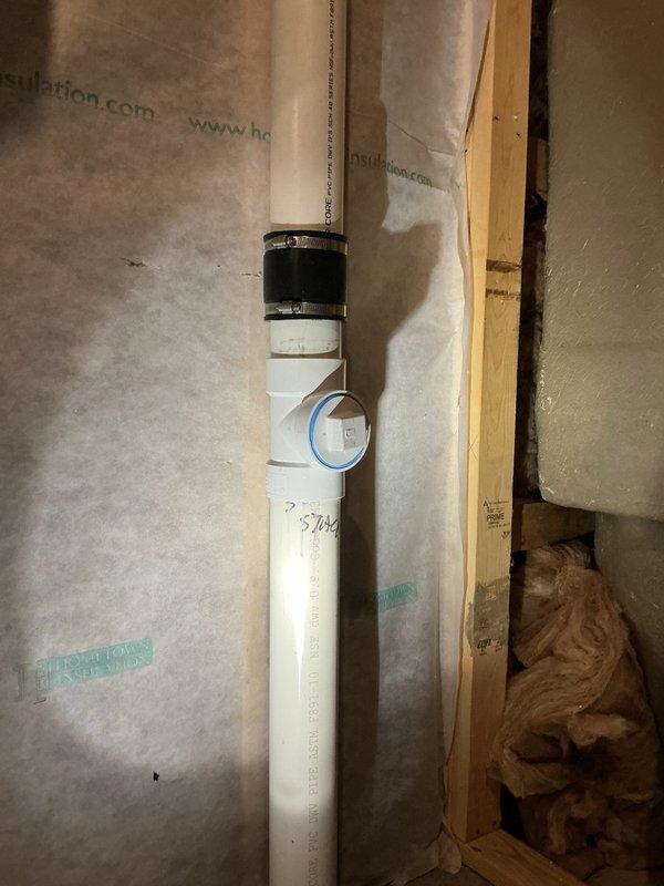 Responded to a water leak complaint originating from the upstairs bathroom with water pooling in the basement. Upon inspection, identified a cracked clean-out tee fitting on the basement drain pipe as the source of the leak. Cut out the damaged clean-out tee and installed a new replacement fitting to restore proper drainage function and eliminate the water intrusion. Documented the deteriorated condition of the original component, which showed significant cracking and surface degradation, and verified the new installation was secure and leak-free.