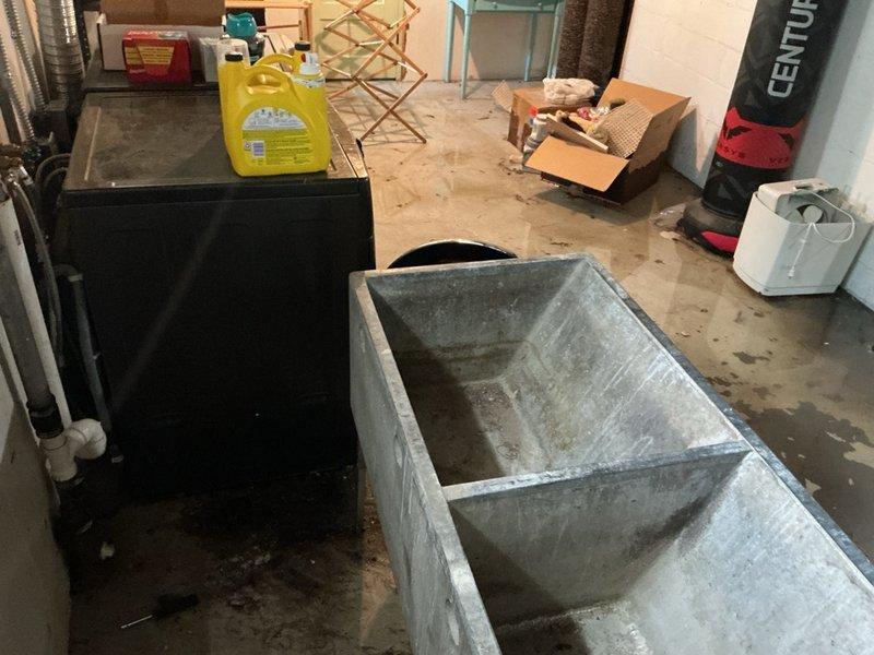 Responded to basement flooding issue originating from clothes washer drainage system. Upon arrival, found extensive standing water throughout laundry area with significant pooling around floor drain. Initial assessment confirmed floor drain was not draining properly following washing machine use.

Conducted thorough inspection of drainage system and identified root cause as multiple breaks in underground drainage piping. The compromised pipe sections were preventing proper water flow and causing backflow into the basement through the floor drain. Documented water damage extent with photographic evidence showing widespread flooding across concrete floor surface.

Due to the severity of underground pipe damage requiring excavation and replacement, coordinated follow-up estimate appointment for comprehensive repair scope including pipe replacement and restoration work.
