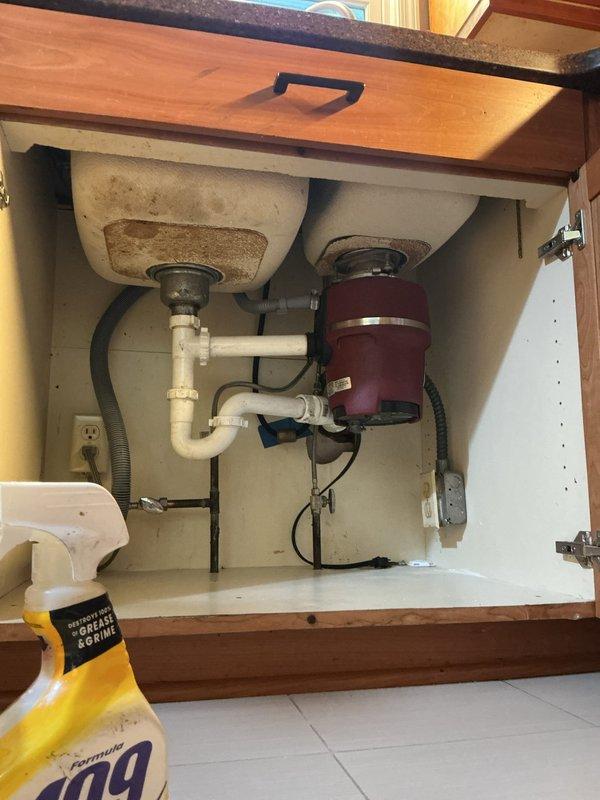 Responded to a backed-up kitchen sink drain that was not draining properly. Diagnosed blockage located beyond the P-trap in the secondary drain line leading to the main. Initially attempted to clear the obstruction using a flex shaft machine but was unable to penetrate the pipe configuration. Successfully deployed a drill snake and cleared the blockage, advancing approximately 20 feet into the drain line before encountering binding resistance that prevented further progress. Attempted camera inspection to assess pipe condition but could not navigate the camera through the vertical section of the drain line. Advised customer that kitchen drain line replacement may be necessary if drainage issues recur. Reassembled all drain components and conducted multiple fill-and-drain tests using the double-basin sink to verify proper flow and check for leaks. All testing confirmed restored drainage function with no leaks detected upon completion.