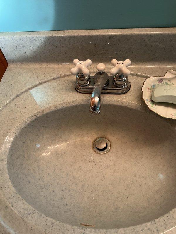 Completed annual plumbing inspection and addressed kitchen faucet flow issue caused by sediment buildup in the aerator head. Removed and cleaned aerator, restoring proper water pressure and flow. Inspected basement plumbing and noted green discoloration on pipes consistent with high pH water conditions; confirmed water softener is functioning correctly. All plumbing fixtures and systems operating within normal parameters.