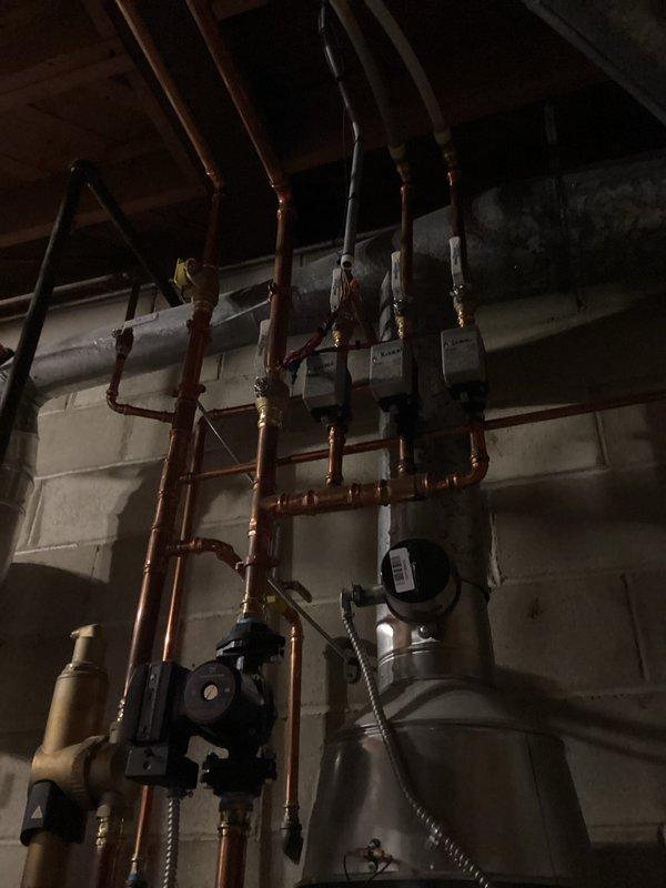 Performed comprehensive pre-season tune-up and inspection on residential boiler system, over 15 years old, that had not been operated since property changed ownership earlier this year. Conducted thorough visual inspection of boiler unit, circulator pumps, expansion tank, and associated copper piping network. Verified proper operation of all zone valves and shut-off valves throughout the hydronic heating system. Inspected all pipe connections, fittings, and joints for signs of corrosion or leakage. Tested circulator pump operation and verified electrical connections to control boxes and safety devices. Examined expansion tank mounting and condition. Cleaned and inspected burner assembly, heat exchanger, and combustion chamber. Verified proper venting and flue pipe integrity. Tested all safety controls including pressure relief valve, low water cutoff, and aquastat settings. System started successfully with no issues noted during operational testing.