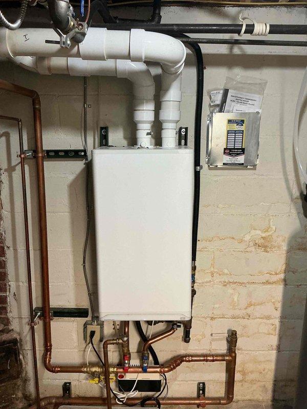 Performed annual boiler maintenance on approximately one-year-old unit. Cleaned routine components, bled radiators to remove air from system, and flushed drain lines. Tested all equipment operation and confirmed system is heating properly with no issues detected.