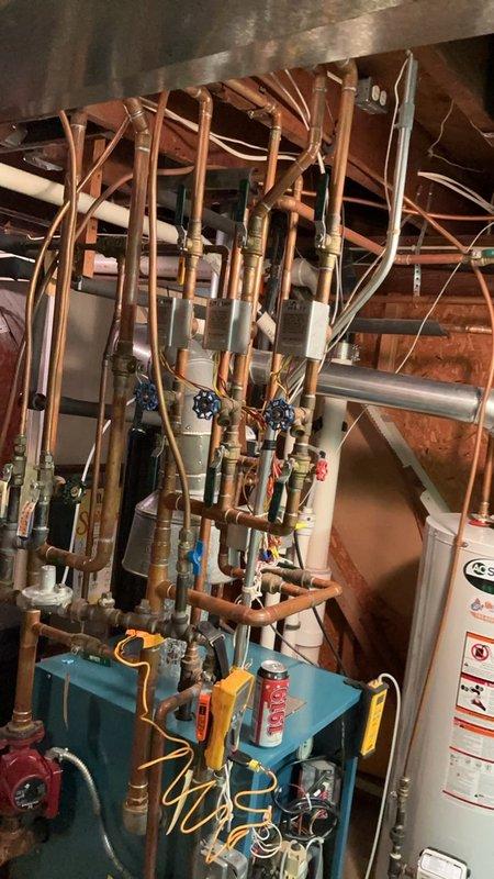 Completed comprehensive boiler tune-up and maintenance service. Thoroughly scrubbed burners, vacuumed debris from under burner assembly and surrounding boiler area. Inspected and verified all five zone valves operating correctly. Performed safety diagnostics including carbon monoxide testing which measured 1 ppm (within safe parameters) and confirmed system pressure at 20 psi. All components functioning properly with no issues identified. System left in optimal operating condition.