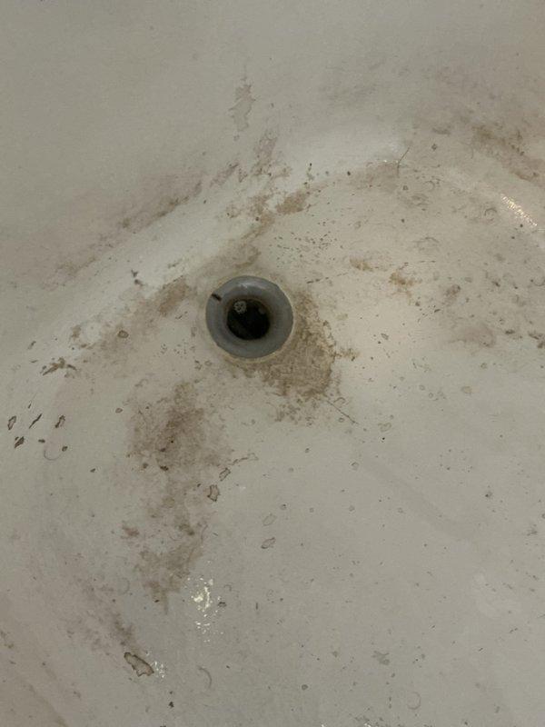 Responded to service call for multiple plumbing issues including main floor lavatory faucet leak, main floor tub backup, and basement shower drain concerns. Upon diagnostic inspection, identified cold side lavatory faucet leaking due to severe internal corrosion requiring complete faucet replacement. Main floor bathtub diagnosed with drainage backup caused by hair blockage in drain line. Basement shower inspection revealed water leakage originating from cracked shower wall seals rather than drain system; drain found to be operating properly with no leaks detected in drain assembly.

Performed drain cable snaking service on main floor bathtub using mechanical auger to clear obstruction. Successfully extracted large hair ball accumulation from drain line. Conducted water flow test following drain clearing to verify proper drainage operation and confirm complete blockage removal. Tub drain now functioning at normal capacity with no backup issues. Provided recommendations for lavatory fauc
