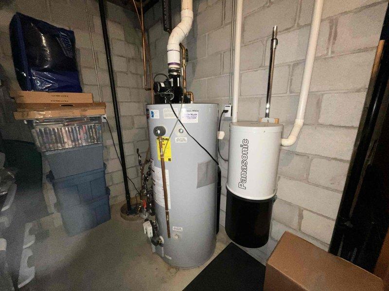 Conducted on-site assessment for replacement of existing water heater with new 75-gallon residential unit. Evaluated current basement utility room configuration, including existing water heater connections, copper and PVC supply lines, drainage systems, and available clearances for installation. Documented existing plumbing infrastructure, overhead piping arrangements, and proximity to HVAC equipment to ensure proper spacing and code compliance for new unit installation. Photographed current setup showing water heater positioning, pipe connections, electrical requirements, and access points for removal and replacement work.