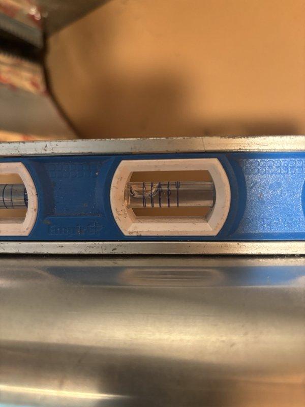 Responded to inspection correction notice for water heater vent connector that was back-pitched and failed to meet code requirements. Cut and repositioned the vertical vent pipe on the water heater to achieve proper 1/4" per foot pitch as required by building code. Verified correct pitch using level and documented the corrected installation with photographs for submission to the building inspector.