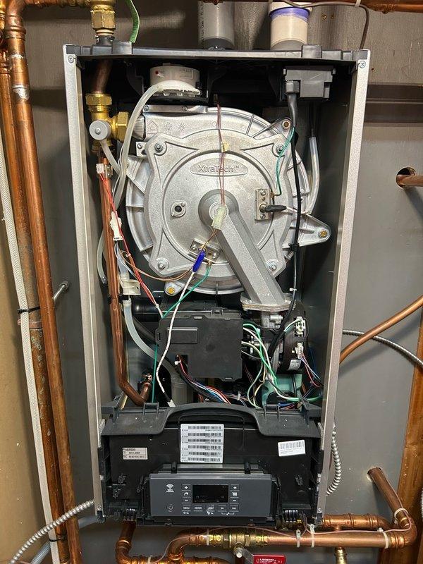 Completed annual fall heating maintenance on a 4-year-old wall-mounted boiler system. Performed comprehensive tune-up including inspection and cleaning of ignition sensor, inducer motor, air flow system, pressure switch, and gas valve. Conducted combustion analysis confirming system operating at 97.8% efficiency with safe carbon monoxide levels. Verified proper gas pressure and scoped heat exchanger with no defects found. Cleared condensate drain trap and removed buildup to ensure proper drainage. Inspected all copper piping connections, expansion tank, brass valves, and electrical components. System tested and confirmed operating properly with no safety concerns identified.