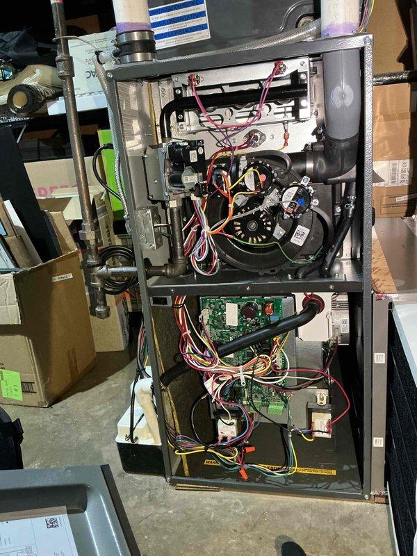 Completed annual heating maintenance visit on Amana heat pump air handler and single-head mini split system. Performed comprehensive tune-up on week-old heat pump air handler including inspection of flame rod, HSI ohms verification within specifications, and amp draw testing on inducer motor and ECM blower motor with all readings within acceptable range. Operated unit in both heat pump and natural gas heating modes, confirmed heat exchanger integrity with no cracks or damage detected, verified 40-degree temperature rise across furnace indicating proper combustion and airflow. Secured loose blower compartment insulation to interior wall using duct tape after identifying missing adhesive. Conducted mini split maintenance including filter cleaning on indoor head unit, verified 21-degree temperature split indicating proper refrigerant charge and heat transfer, confirmed all fan motors operating correctly, and inspected drain lines with no blockages found. All systems tested and operating w