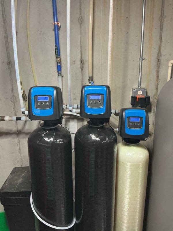 Responded to basement flooding caused by water softener system drainage issue. Upon inspection, determined that the drain line was unable to handle simultaneous regeneration cycles from multiple water treatment units, resulting in drain overflow and water accumulation in the basement. Resolved the issue by reprogramming and staggering the regeneration run times of the water softener units to prevent overlap, ensuring only one unit drains at a time and eliminating the flooding condition.