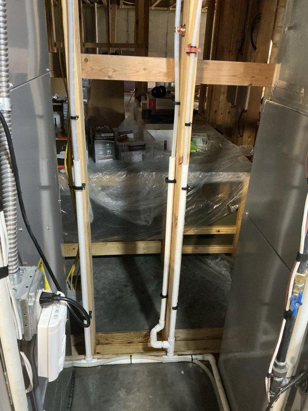 Responded to basement flooding caused by water softener system drainage issue. Upon inspection, determined that the drain line was unable to handle simultaneous regeneration cycles from multiple water treatment units, resulting in drain overflow and water accumulation in the basement. Resolved the issue by reprogramming and staggering the regeneration run times of the water softener units to prevent overlap, ensuring only one unit drains at a time and eliminating the flooding condition.