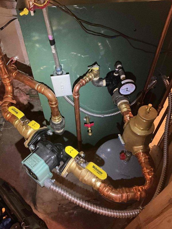 Responded to follow-up visit for boiler system installed in December. Customer reported previous return visits for pressure gauge reading incorrectly. Building inspector required gauge orientation changed from vertical to horizontal mounting to meet code requirements. Removed existing pressure gauge and connecting line from boiler system. Installed new pressure gauge in horizontal orientation per manufacturer specifications and inspector requirements. Verified all other system components including circulator pump, piping connections, brass fittings, and electrical connections remained operational and properly configured. Tested gauge for accurate pressure readings and confirmed proper system operation. Documented installation with photographs showing corrected gauge orientation and complete piping assembly.