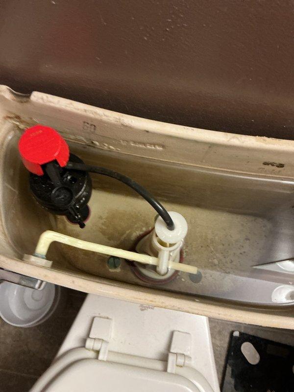 Conducted comprehensive plumbing inspection of residential property built in 2007. Inspected toilet tank flush mechanism and fill valve components, noting mineral deposits and sediment buildup in tank, and evaluated bathroom shower/tub plumbing fixtures and diverter valve operation to ensure proper functionality.