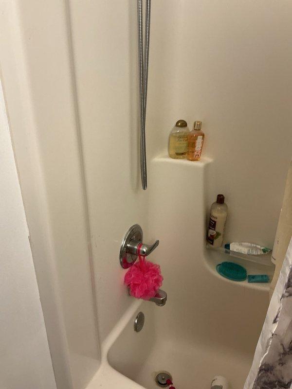 Conducted comprehensive plumbing inspection of residential property built in 2007. Inspected toilet tank flush mechanism and fill valve components, noting mineral deposits and sediment buildup in tank, and evaluated bathroom shower/tub plumbing fixtures and diverter valve operation to ensure proper functionality.
