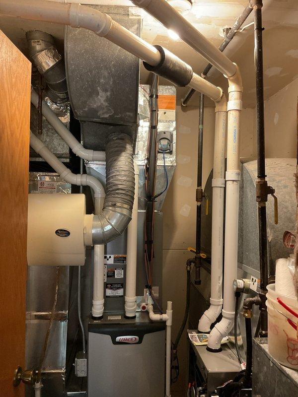 Completed annual maintenance on two residential furnaces in basement mechanical room. Both units were thoroughly inspected and serviced according to standard tune-up procedures. The 3-year-old Lennox furnace and 8-year-old unit both received full preventative maintenance including filter inspection, burner cleaning, heat exchanger examination, blower motor lubrication, and safety control testing. Verified proper operation of all components, checked gas pressure, tested ignition systems, and confirmed adequate combustion air supply. All venting connections and PVC condensate drain lines were inspected and found secure. Both systems are operating efficiently with no immediate concerns noted.