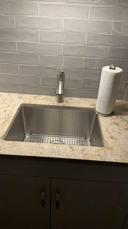 Completed comprehensive Family Rewards plumbing inspection at owner-occupied residential property. Inspected kitchen plumbing system including undermount stainless steel sink with brushed stainless steel pull-down faucet, verified proper operation and absence of leaks. Examined appliance plumbing connections, flexible supply hoses, and drain components with hose clamps secured properly. All plumbing fixtures and connections found in good working order with no issues identified during inspection.