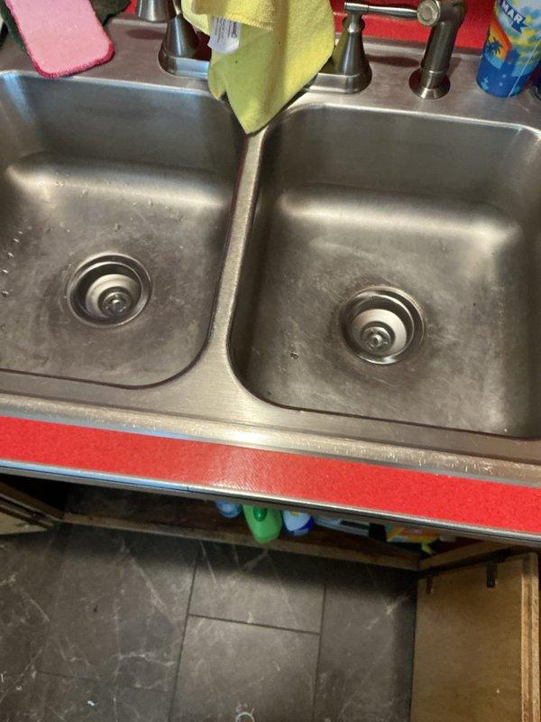 Responded to service call for leaking tubular piping and basket strainers under double-basin kitchen sink. Upon inspection, determined that existing under-sink drainage assembly had failed and required complete replacement. Removed deteriorated tubular piping, P-traps, and both basket strainers from the double-basin stainless steel sink installation. Installed two new basket strainers with proper sealing, connected new PVC tubular piping including end waste assembly and trap configuration suitable for dual-basin setup. Verified all connections were secure and properly aligned. Conducted operational testing by filling both sink basins and releasing water to confirm proper drainage flow and verify leak-free performance of all newly installed components. System functioning as designed with no leaks detected.