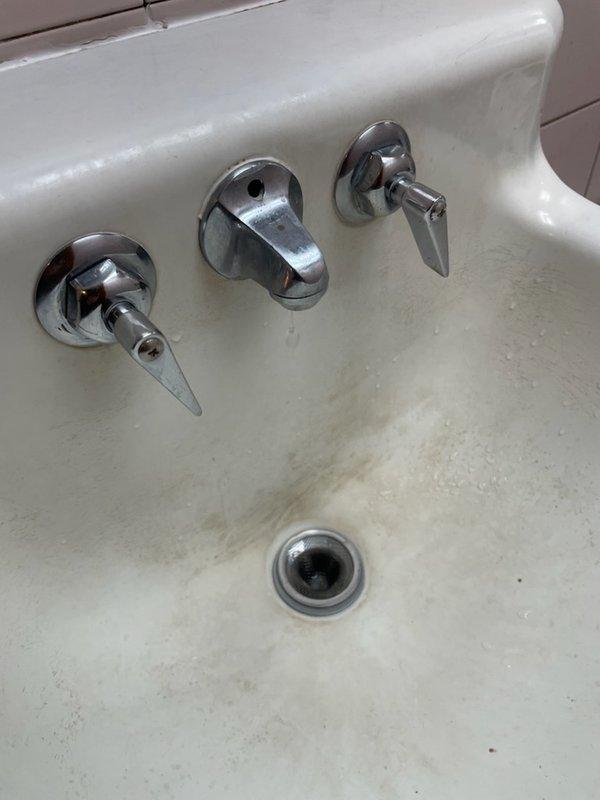 Responded to reports of excessive water usage and multiple fixture leaks throughout the facility. Diagnosed and repaired continuously running toilet in downstairs bathroom by replacing handle and flapper assembly. Pulled and reset men's restroom toilet with new wax ring seal to address leaking at base. Performed temporary repair on women's restroom lavatory faucet by replacing flat washers on pitted seats to stop slow drip until permanent fixture replacement can be scheduled.