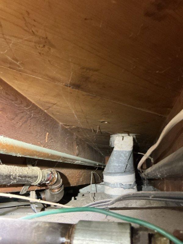 Responded to gas leak service call on furnace supply line. Upon arrival, performed comprehensive leak detection inspection of gas piping system in basement. Property has dual gas meter configuration with separate lines serving residence and adjacent unit. 

Identified two active gas leaks at pipe fittings: one at T-joint connection serving water heater and one at 45-degree elbow joint on furnace supply line. Conducted thorough leak testing of downstream components including furnace gas valve and water heater connections, confirming no leaks present at appliance connection points. Leaks isolated to upstream pipe fittings showing visible corrosion and deterioration at joint connections.

Documented leak locations with photographs showing corroded elbow fitting and affected piping in crawl space area. Repair estimate required for replacement of compromised T-joint and 45-degree elbow fittings. Follow-up appointment needed for permanent repair work.