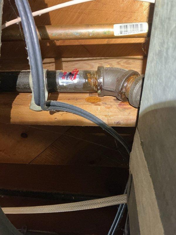 Responded to gas leak service call on furnace supply line. Upon arrival, performed comprehensive leak detection inspection of gas piping system in basement. Property has dual gas meter configuration with separate lines serving residence and adjacent unit. 

Identified two active gas leaks at pipe fittings: one at T-joint connection serving water heater and one at 45-degree elbow joint on furnace supply line. Conducted thorough leak testing of downstream components including furnace gas valve and water heater connections, confirming no leaks present at appliance connection points. Leaks isolated to upstream pipe fittings showing visible corrosion and deterioration at joint connections.

Documented leak locations with photographs showing corroded elbow fitting and affected piping in crawl space area. Repair estimate required for replacement of compromised T-joint and 45-degree elbow fittings. Follow-up appointment needed for permanent repair work.